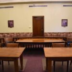 Empty courtroom with wooden tables and gallery seating