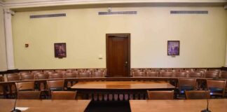 Empty courtroom with wooden tables and gallery seating
