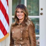 woman smiling in a brown suede coat