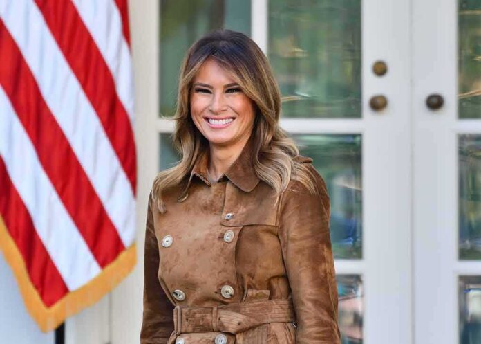 woman smiling in a brown suede coat