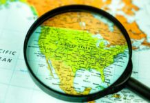 Magnifying glass focusing on a map of the United States