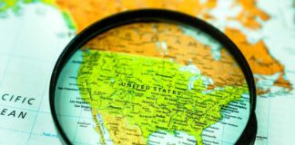 Magnifying glass focusing on a map of the United States