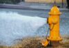 DEADLY Explosive Blast Rips Through Apartment Building Yellow fire hydrant gushing water onto a street