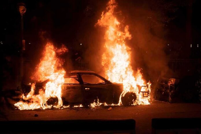 Burning car engulfed in flames at night