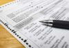 Ballot paper with pen on wooden surface
