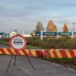 Ukraine border crossing with stop sign and barrier