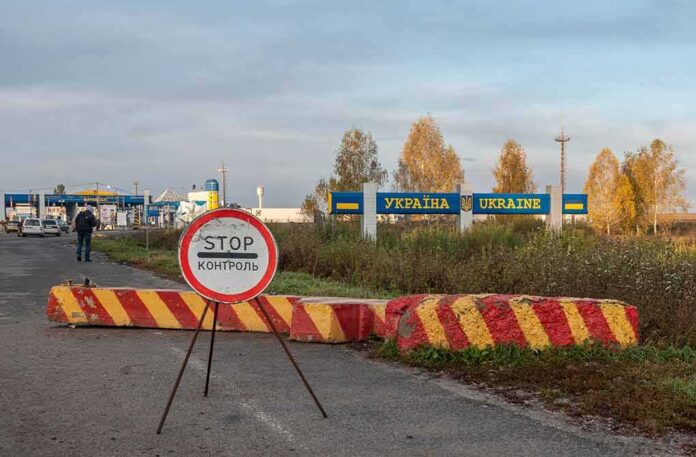 Ukraine border crossing with stop sign and barrier