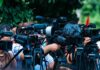 Airport Runway Disaster Leaves 5 DEAD TV news cameras crowding together at an outdoor event
