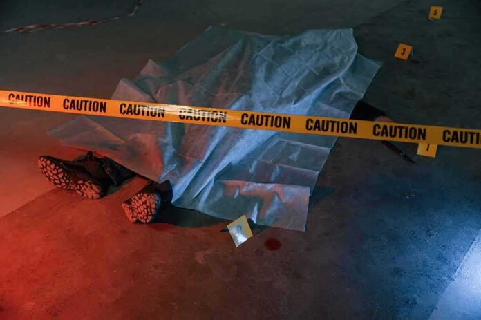 crime scene body under sheet behind caution tape
