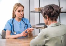 Healthcare professional consulting with an older woman at a desk