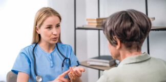 Healthcare professional consulting with an older woman at a desk