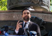 Zohran Mamdani speaking at an outdoor press conference