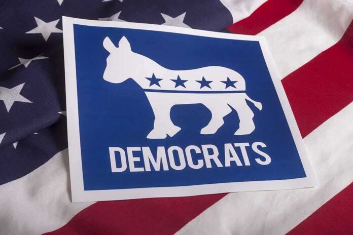 shutterstock_305852213 Democrats donkey symbol on a blue sign over an American flag