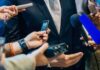 President Accounts HACKED – Loses Millions Of Docs! businessperson in suit surrounded by microphones and recorders