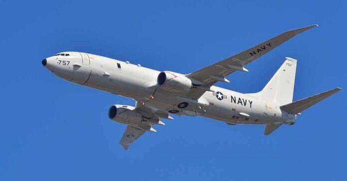 US Navy patrol aircraft flying against a clear blue sky