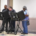 Lester Bowie and Miriam Tlali using electronic voting machines at a polling place