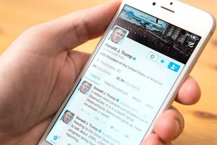 hand holding smartphone showing a social media profile