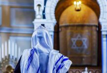El-Sayed’s Lesbian Rosh Hashanah Plan BACKFIRES Spectacularly Person in white and blue prayer shawl facing ornate interior