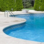 Outdoor swimming pool with curved edge and diving board