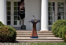 Trump Commands Death Penalty Push – Stuns Rose Garden Podium with presidential seal in a garden colonnade