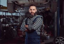 Seven Million Men Vanish From U.S Work Force – WHY? Auto mechanic standing with arms crossed in a garage
