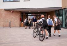 Students in uniforms arriving at a school entrance