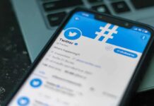 Talarico Mocks GOP Women, Calls Them All Strippers! Smartphone displaying Twitter app on a laptop keyboard