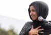 Feds SUBPOENA Ilhan Omar’s Family! Ilhan Omar speaking at a microphone with hand on chest