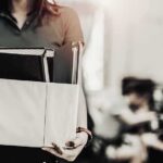 Person carrying a box of office items