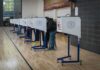 Sydney Sweeney Makes the Case for Voter ID in Brilliant Ad Voters at polling booths in a gymnasium
