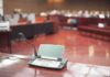 Saudi Spy ARRESTED – FBI Pounces Fast Conference microphone on a desk in a courtroom