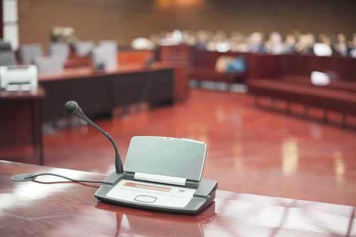 shutterstock_185379551 Conference microphone on a desk in a courtroom