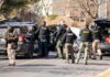 Navy Chief Snared In Child Sting Police and sheriff officers gather around vehicles on a suburban street