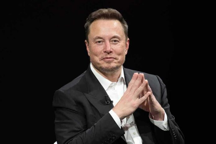 Elon Musk seated in a black suit with hands clasped