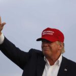 Trump To Gift MLB Icon Presidential Medal of Freedom Donald Trump waving in a red cap
