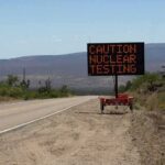 Electronic roadside sign warning of nuclear testing in desert