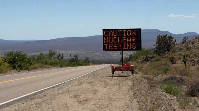 Electronic roadside sign warning of nuclear testing in desert