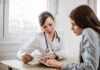 Nation Euthanized Over 1,000 For Insane Reasons Doctor consulting a patient at a desk
